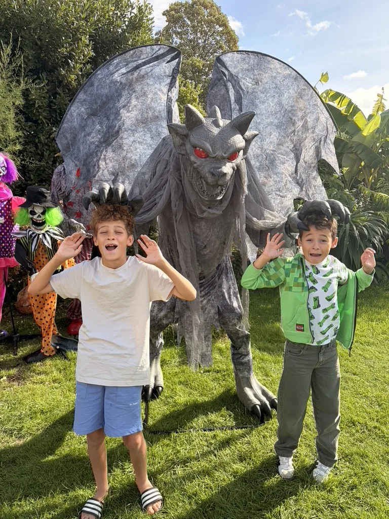 Dexter and his brother Casper with the winged gargoyle in the garden
